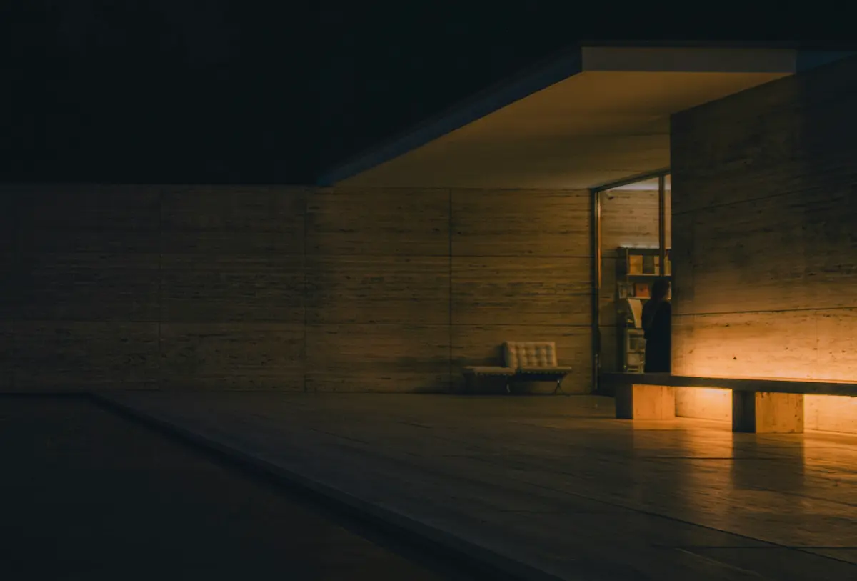 A calm architectural interior with dusk light through glass